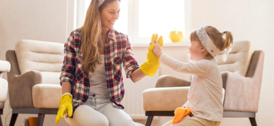 A mother teaching her daughter how to spring clean