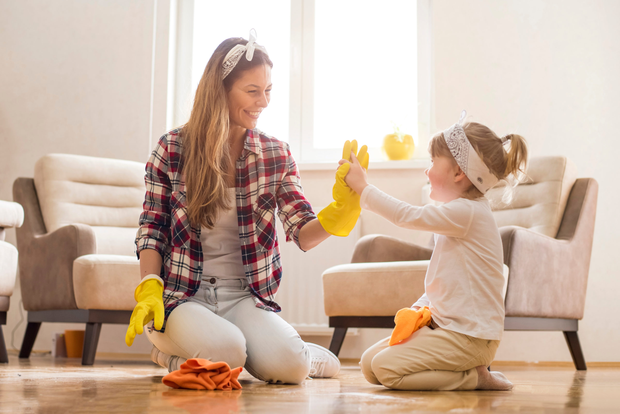 A mother teaching her daughter how to spring clean
