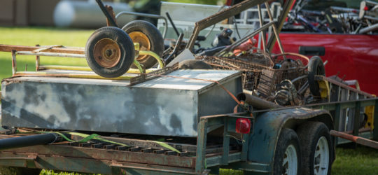 Scrap Metal and Junk Loaded on Trailer A truck hauling away junk and scrap metal