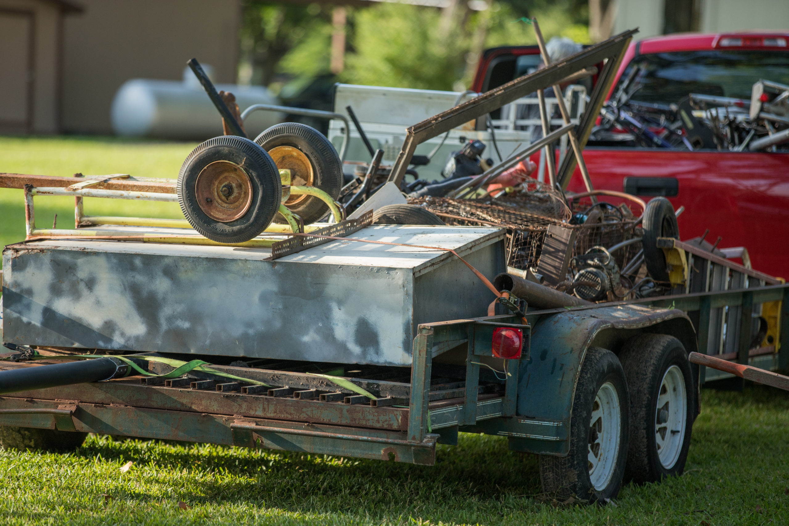 A truck hauling away junk and scrap metal