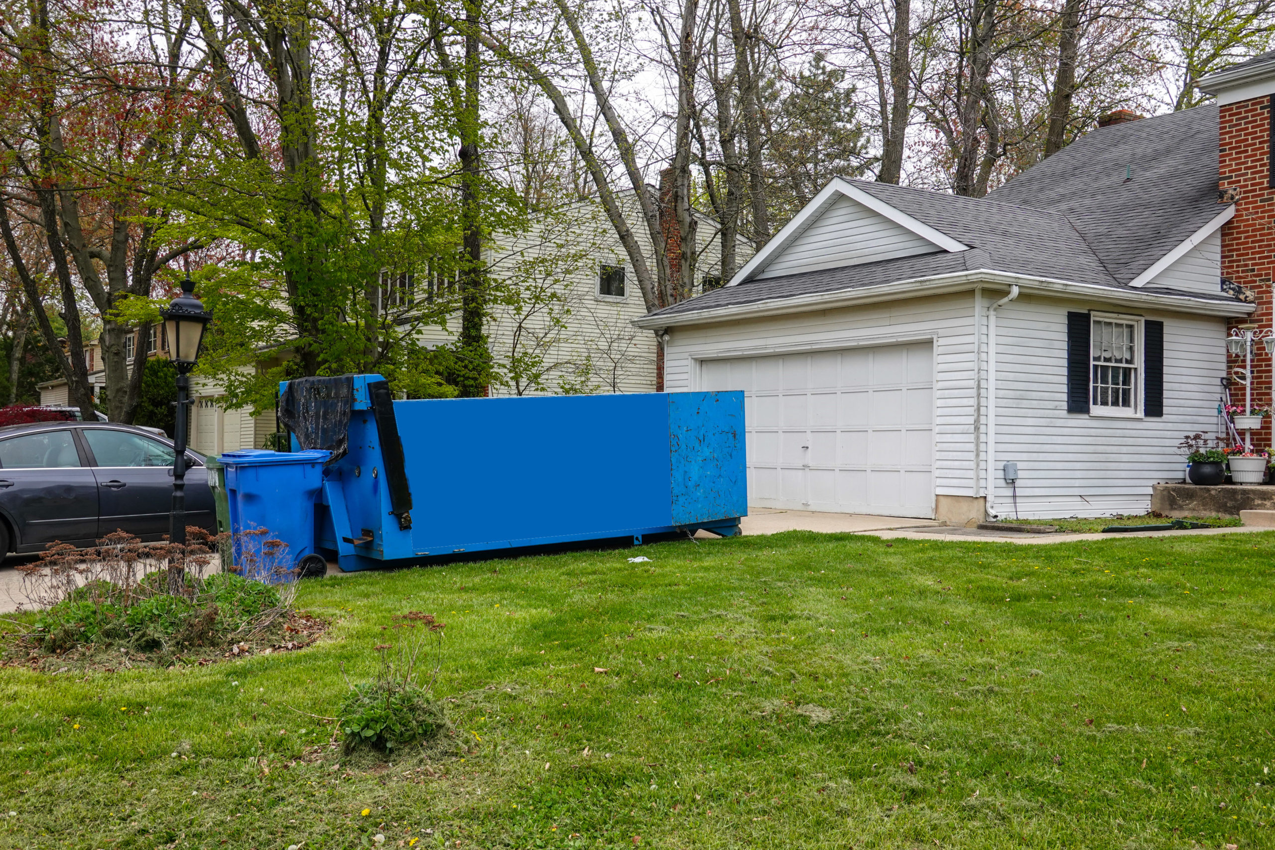 A dumpster in front of a home for spring cleaning