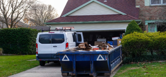 A dumpster bin full of a hoarder's unnecessary belongings.