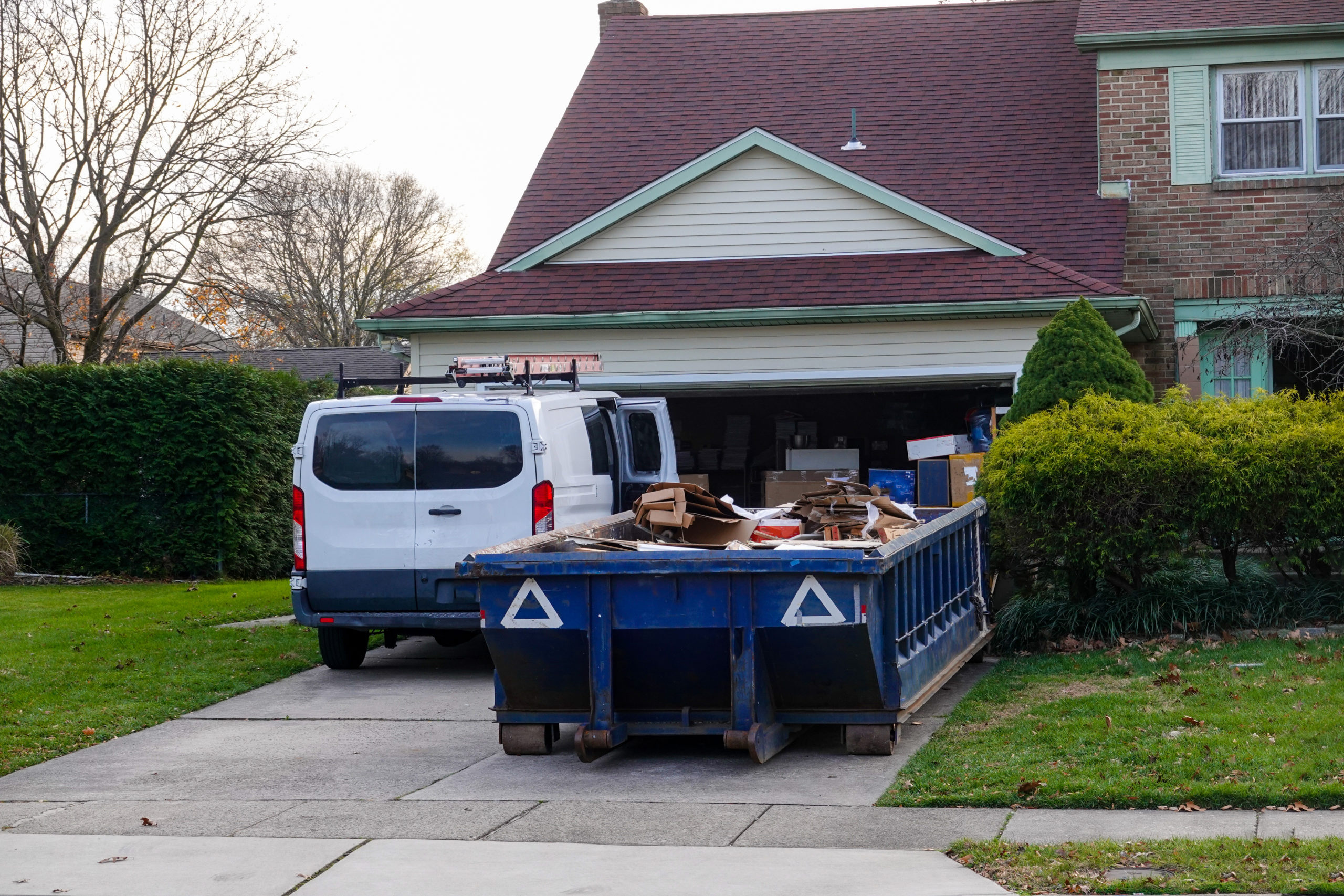 A dumpster bin full of a hoarder's unnecessary belongings.